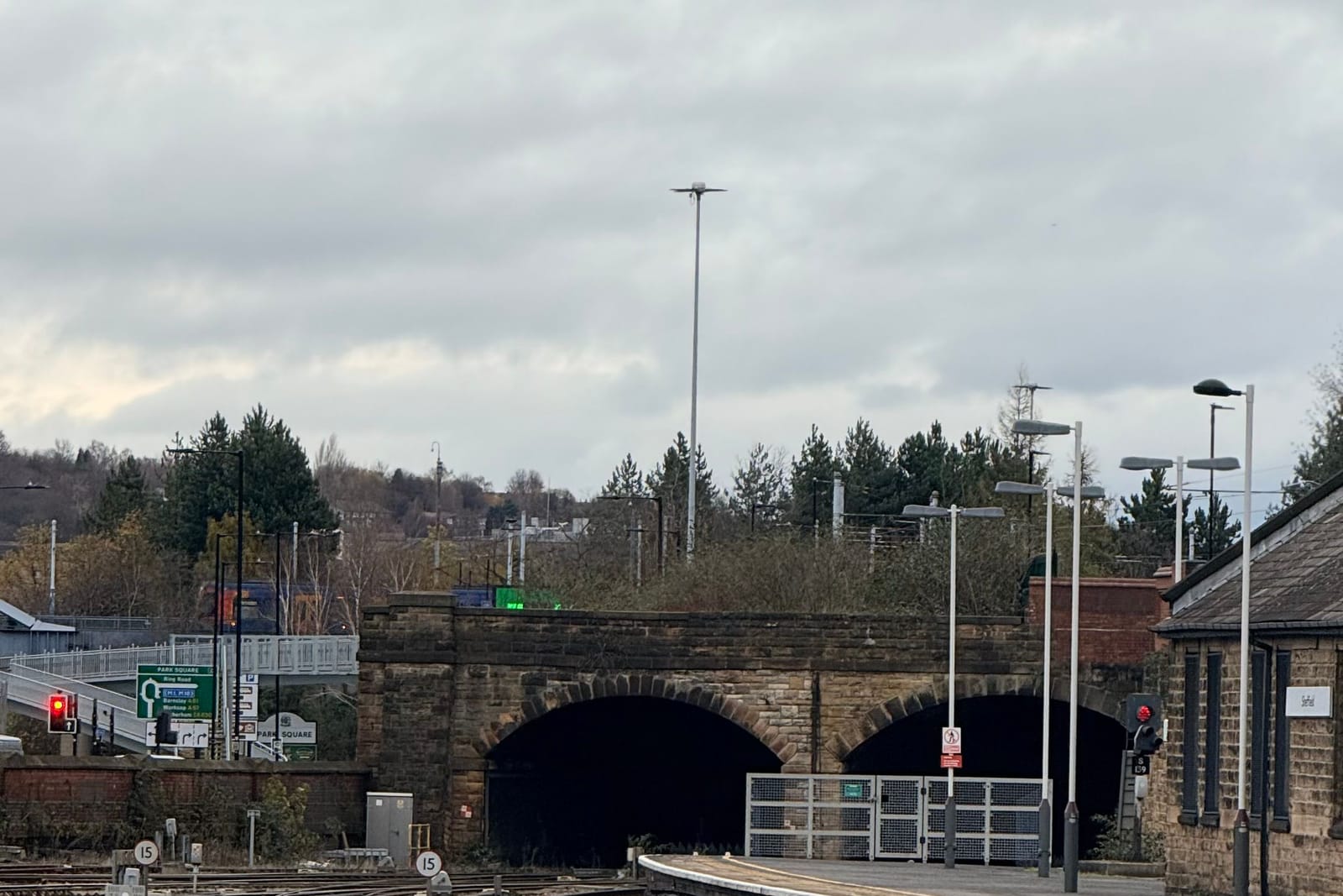 Railway tracks, signals and twin tunnel mouths beyond the platforms at Sheffield station on an overcast day